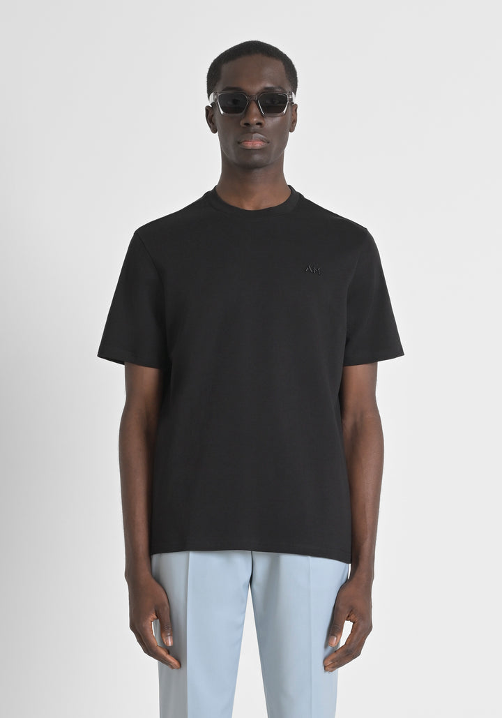 CAMISETA RELAXED FIT DE PUNTO DE ALGODÓN PURO CON DETALLES PERFORADOS Y PLACA METÁLICA